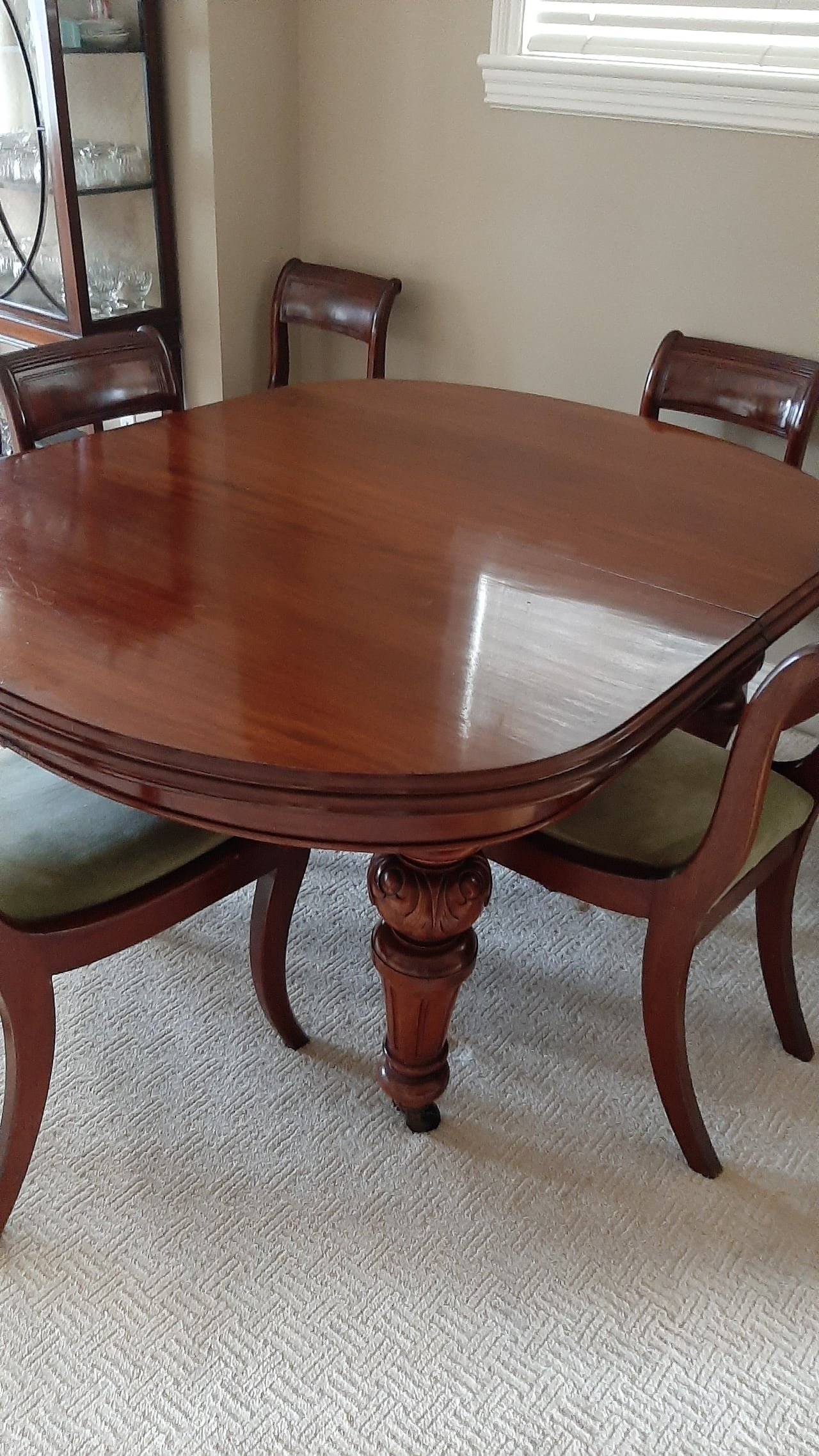 Mahogany dining room table and a glass china cabinet